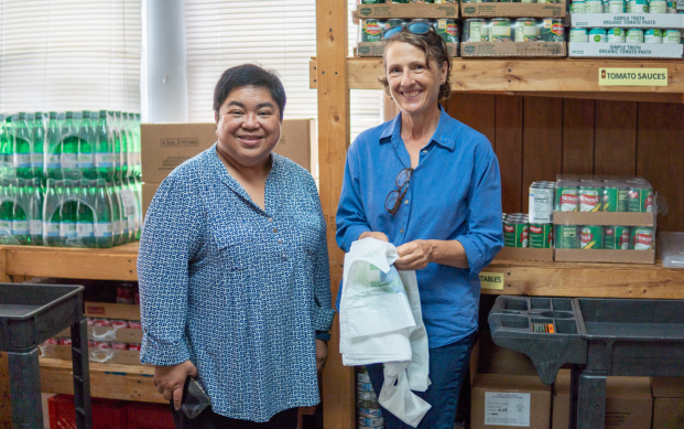 Terry Guerra, community development (right) shares a smile inside the food panty.  manager