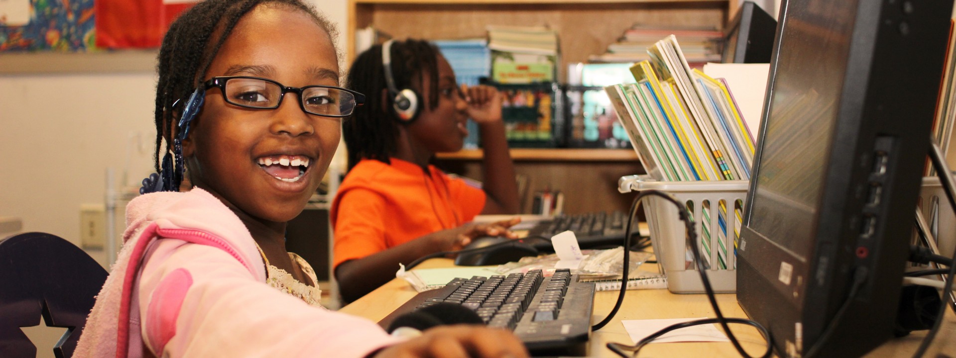 Smiling children using computers at the Honickman Learning Center Comcast Technology Labs