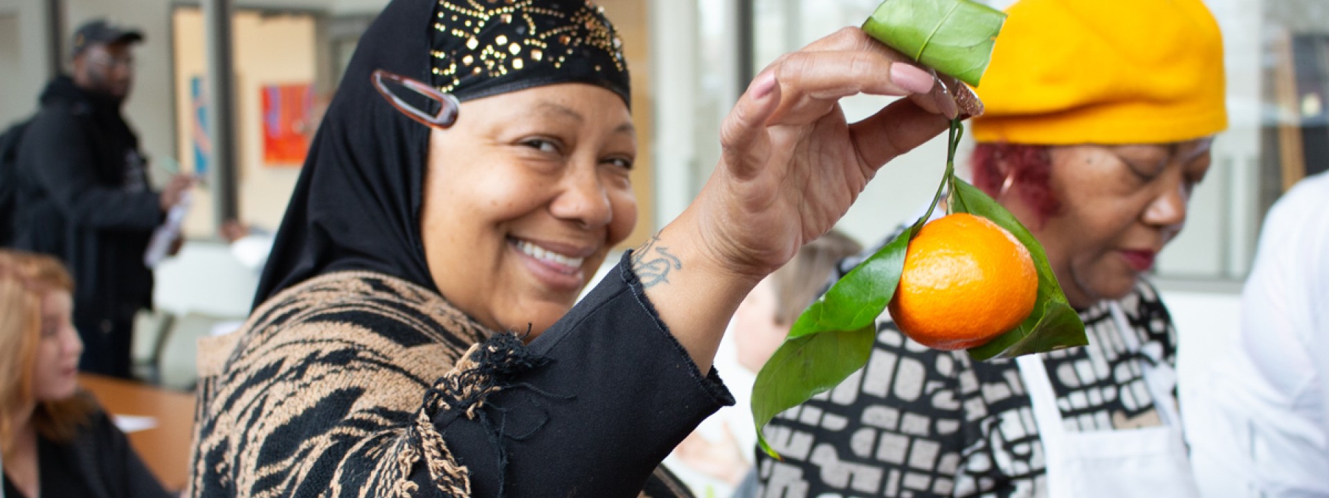 Person holding an orange at a wellness class