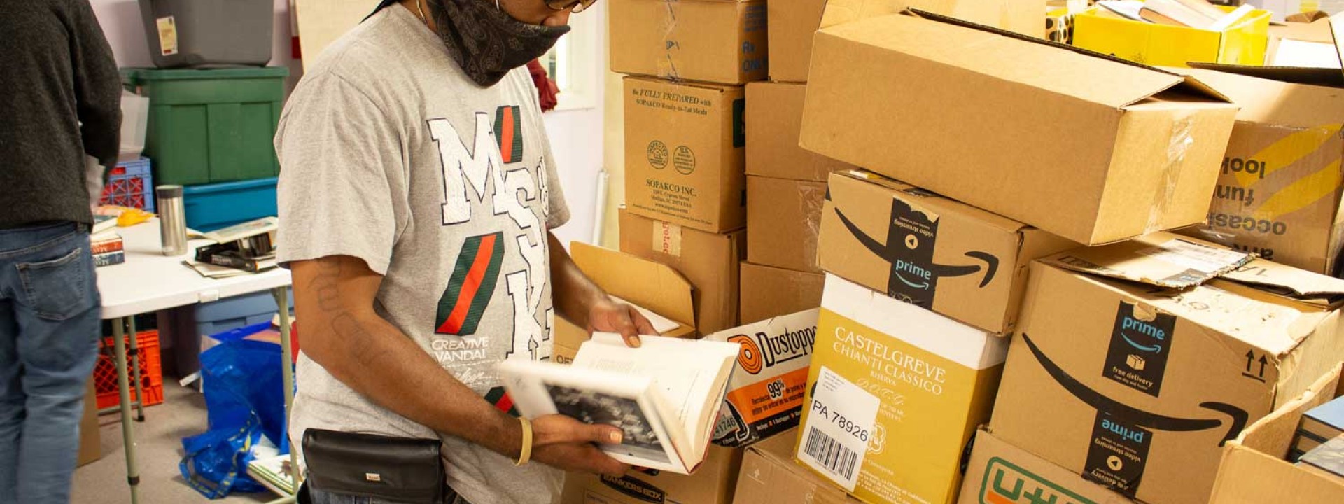 A Project HOME staffer sorts books