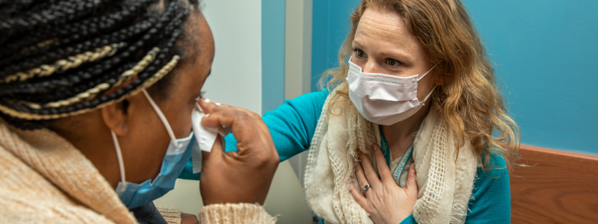 A healthcare provider comforts a patient