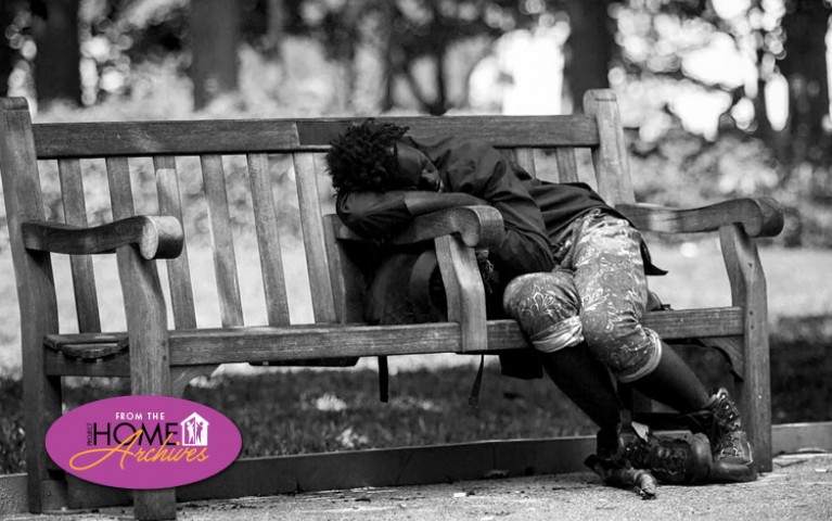 Man sleeping on park bench