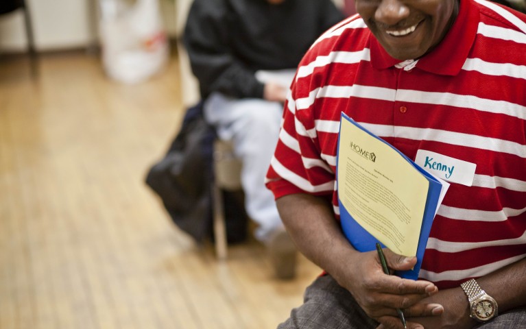 Person holding Speakers Bureau information while at a training