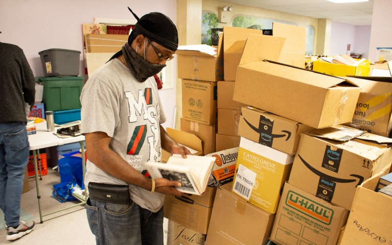 A Project HOME staffer sorts books