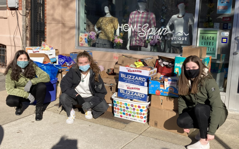(From left to right) Mila Acosta-Morales, Maddie Seipp, and Jordyn Fuges, students at Central Bucks High School West in Doylestown dropping of their books in front of Project HOME’s resale store at 1523 Fairmount Avenue. PHOTO CREDIT: Julie Thomas