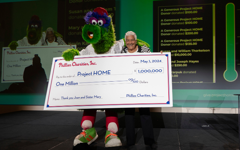 The Phillie Phanatic holds a ceremonial check for one million dollars