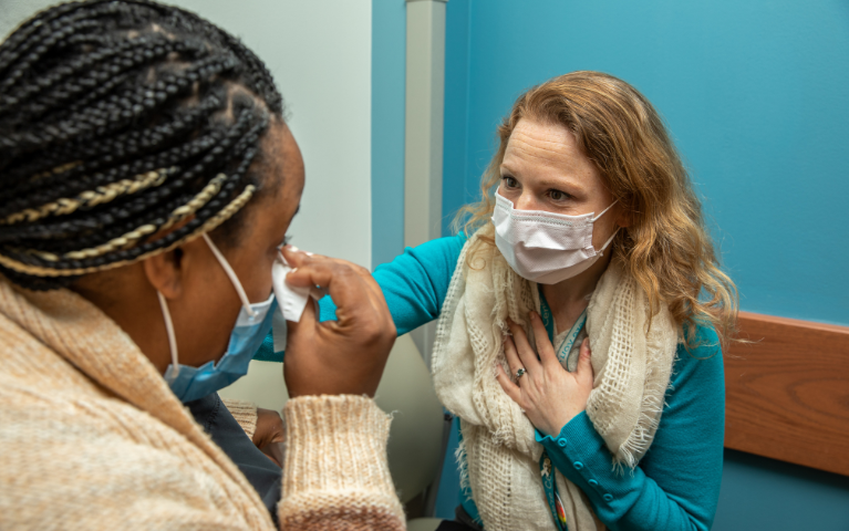 A medical professional comforting a patient