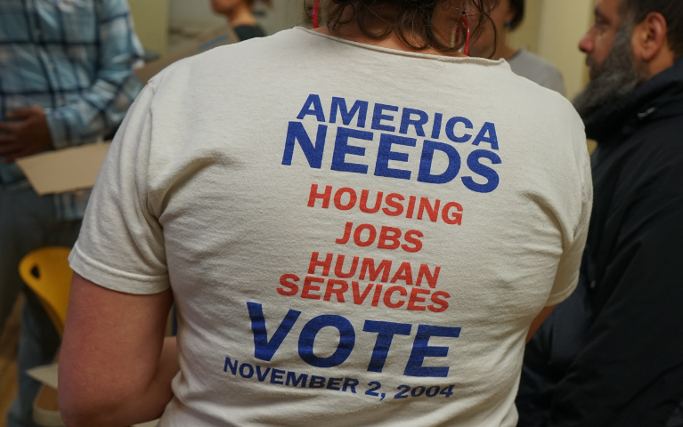 Person wearing a t-shirt with a slogan about voting.