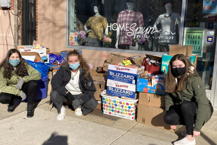 (From left to right) Mila Acosta-Morales, Maddie Seipp, and Jordyn Fuges, students at Central Bucks High School West in Doylestown dropping of their books in front of Project HOME’s resale store at 1523 Fairmount Avenue. PHOTO CREDIT: Julie Thomas