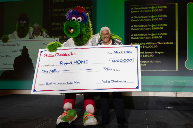 The Phillie Phanatic holds a ceremonial check for one million dollars