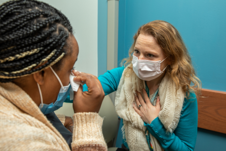 A medical professional comforting a patient